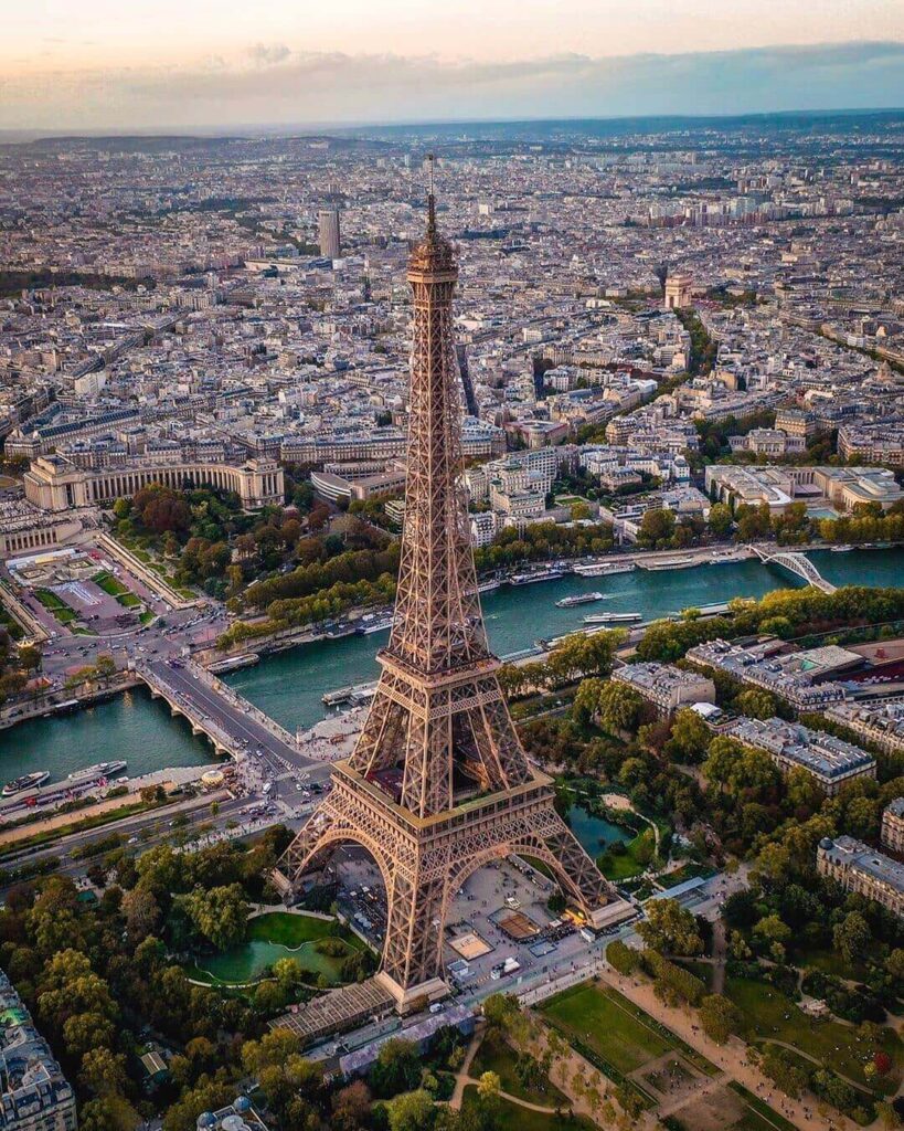 Eiffel Tower blending into the Paris skyline among surrounding buildings