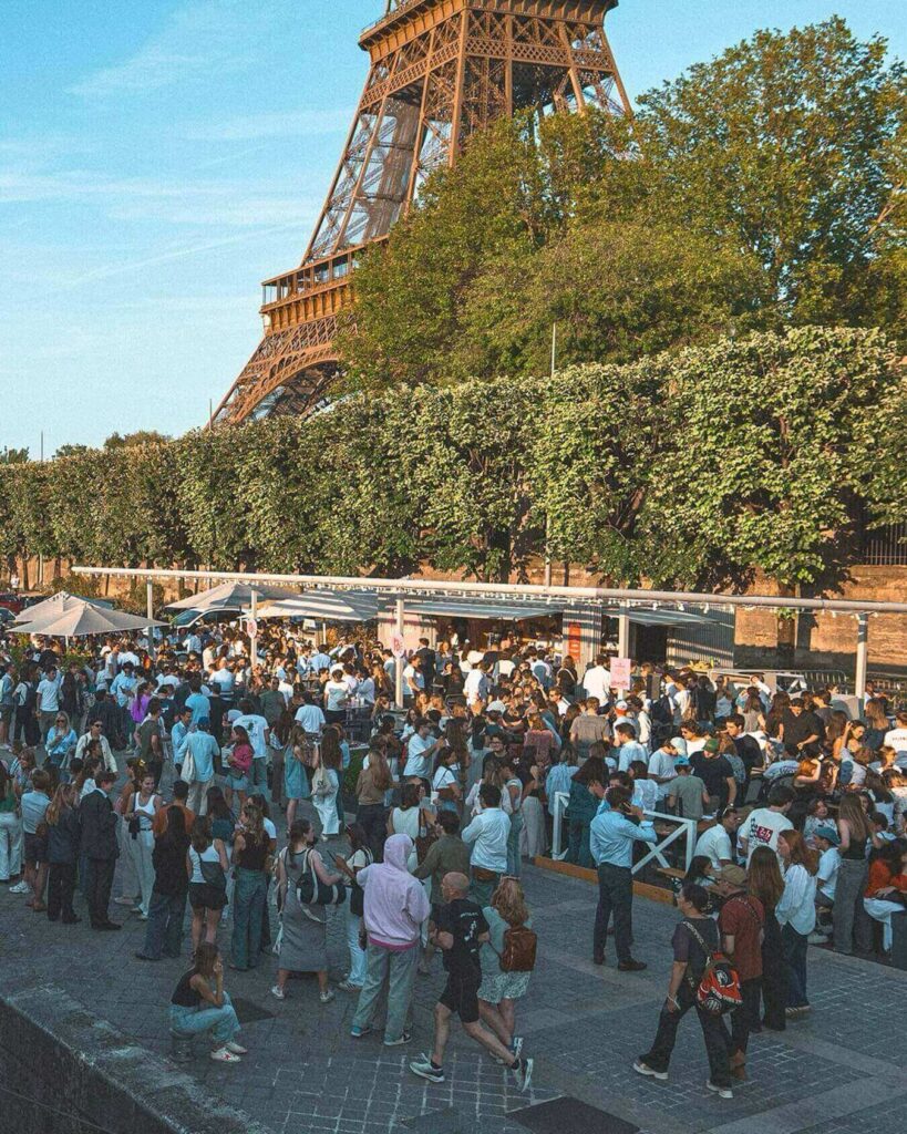 Eiffel Tower in summer with long daylight hours and crowds in Paris