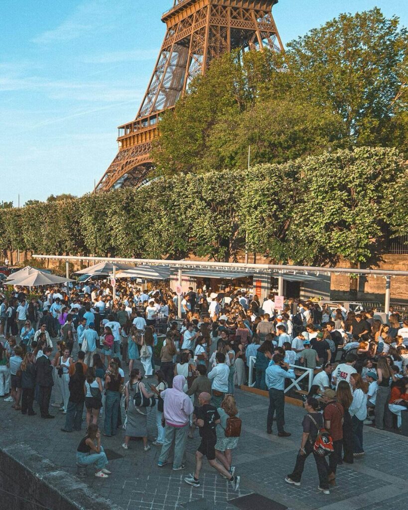 Visitors waiting in a long line to enter the Eiffel Tower in Paris