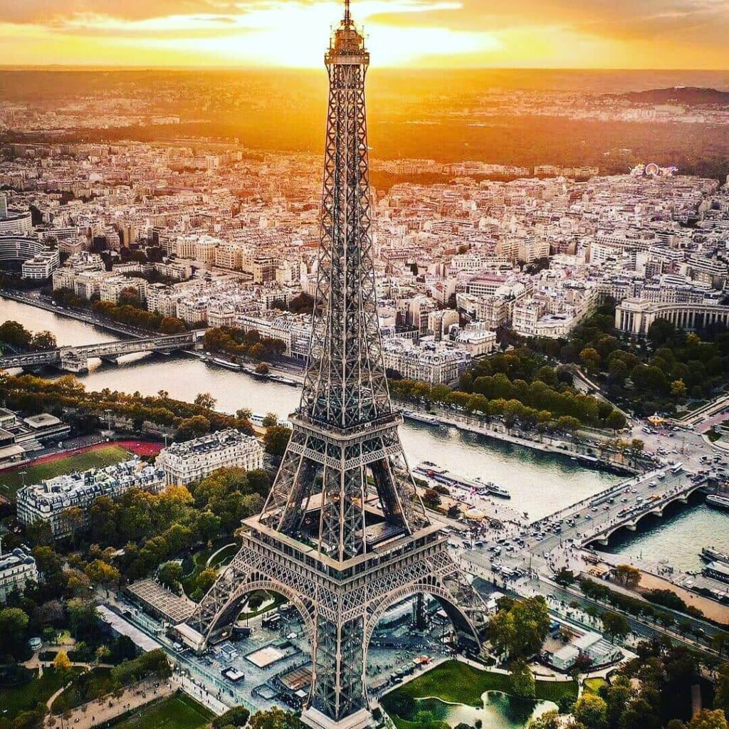 Person walking through Paris with the Eiffel Tower visible in the background