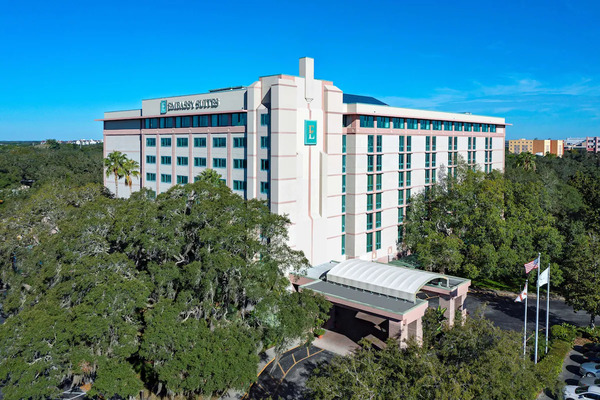 Contemporary Embassy Suites by Hilton Tampa USF/Near Busch Gardens featuring spacious suite accommodations, bright atrium lobby, tropical outdoor pool, and convenient family-friendly stay near Busch Gardens Tampa Bay.