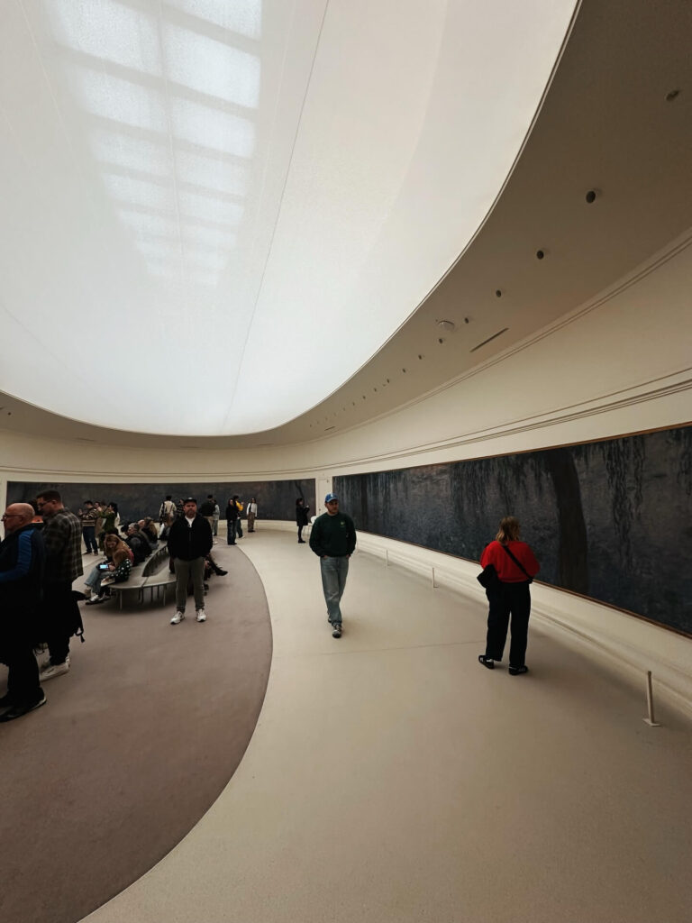 Visitor exploring galleries inside Musée de l'Orangerie in Paris