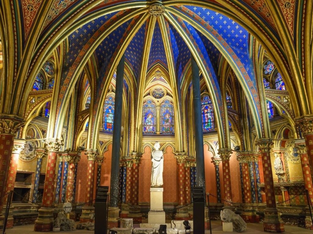 Visitors exploring the upper chapel of Sainte-Chapelle