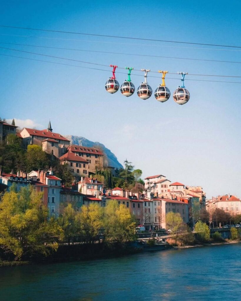 Bubble cable cars rising above Grenoble toward the Bastille