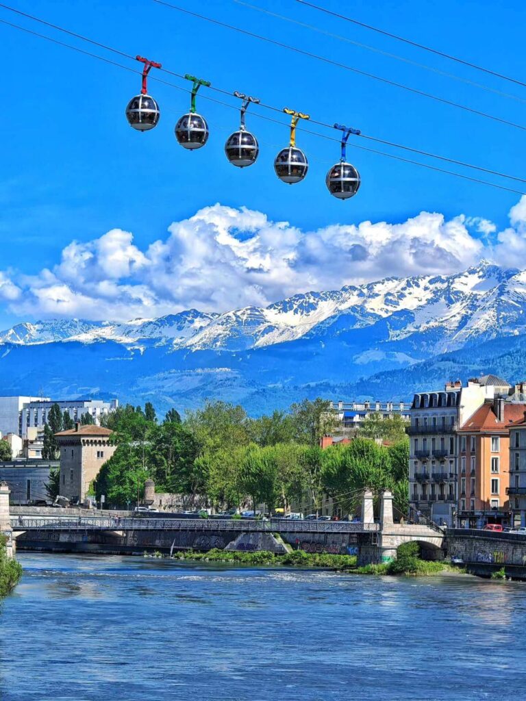 Bubble cable cars rising above Grenoble toward the Bastille