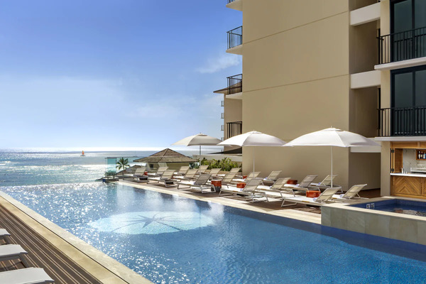 Modern luxury exterior of Halepuna Waikiki by Halekulani featuring elegant accommodations and upscale island hospitality near Waikiki Beach in Hawaii.