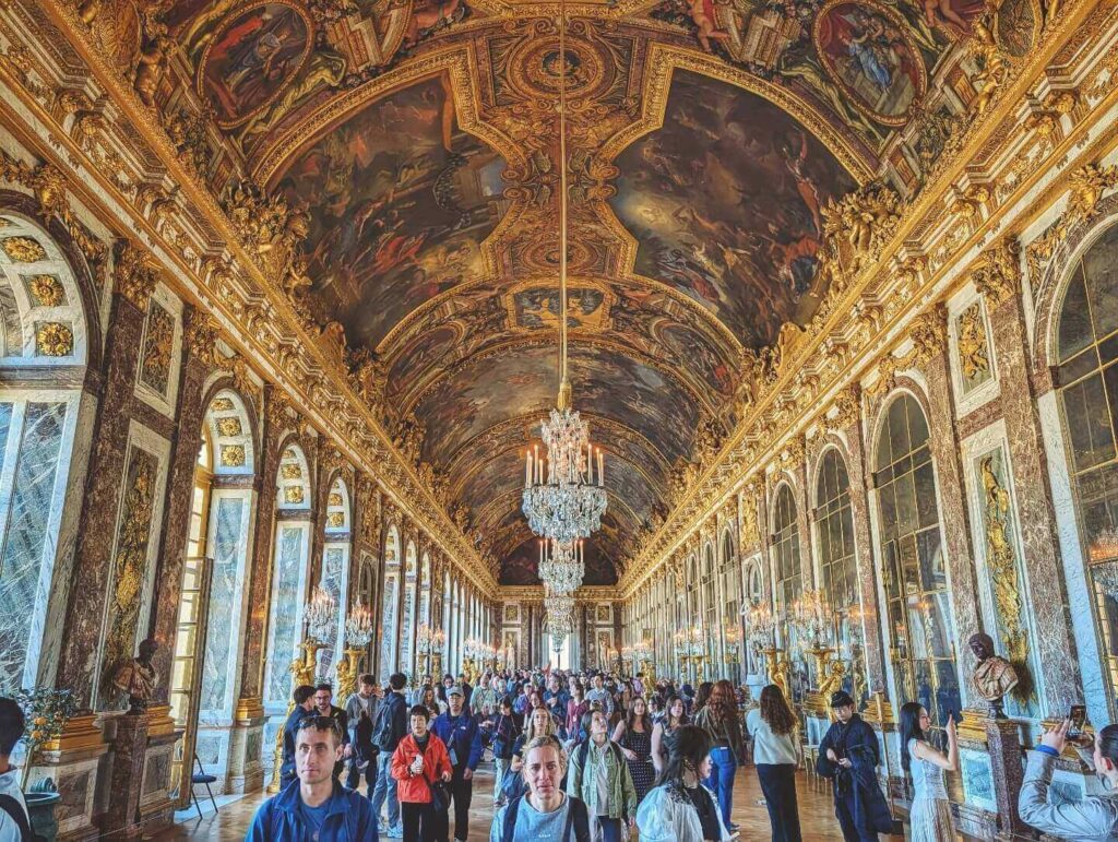Hall of Mirrors at the Palace of Versailles with chandeliers and reflective walls
