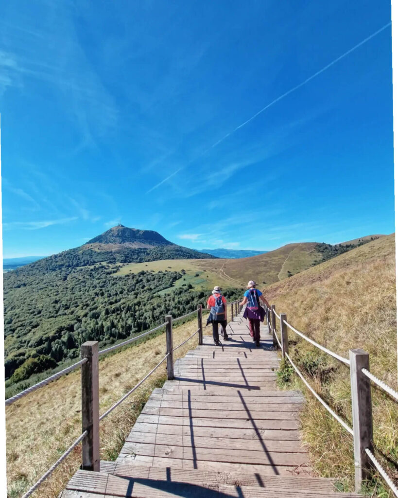 Hiker overlooking volcanic hills at Puy de Dôme