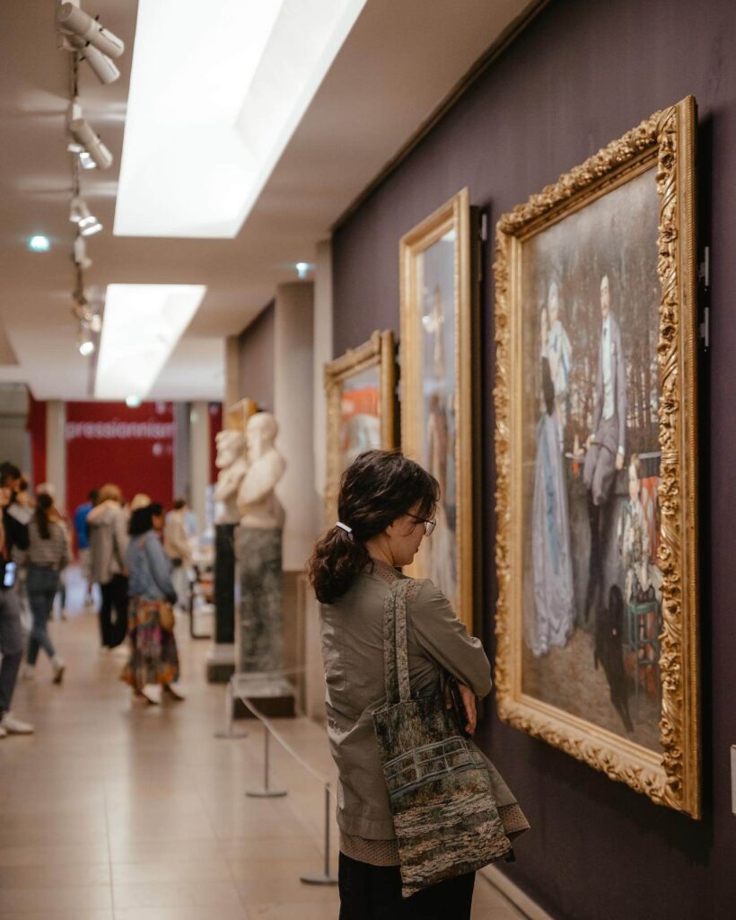 Visitor exploring the upper galleries inside Musée d'Orsay Paris