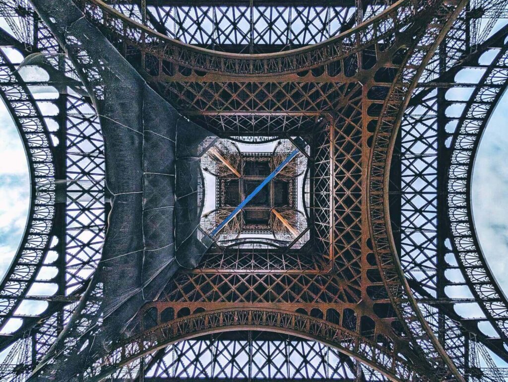 Interior view of the Eiffel Tower structure and elevator moving upward