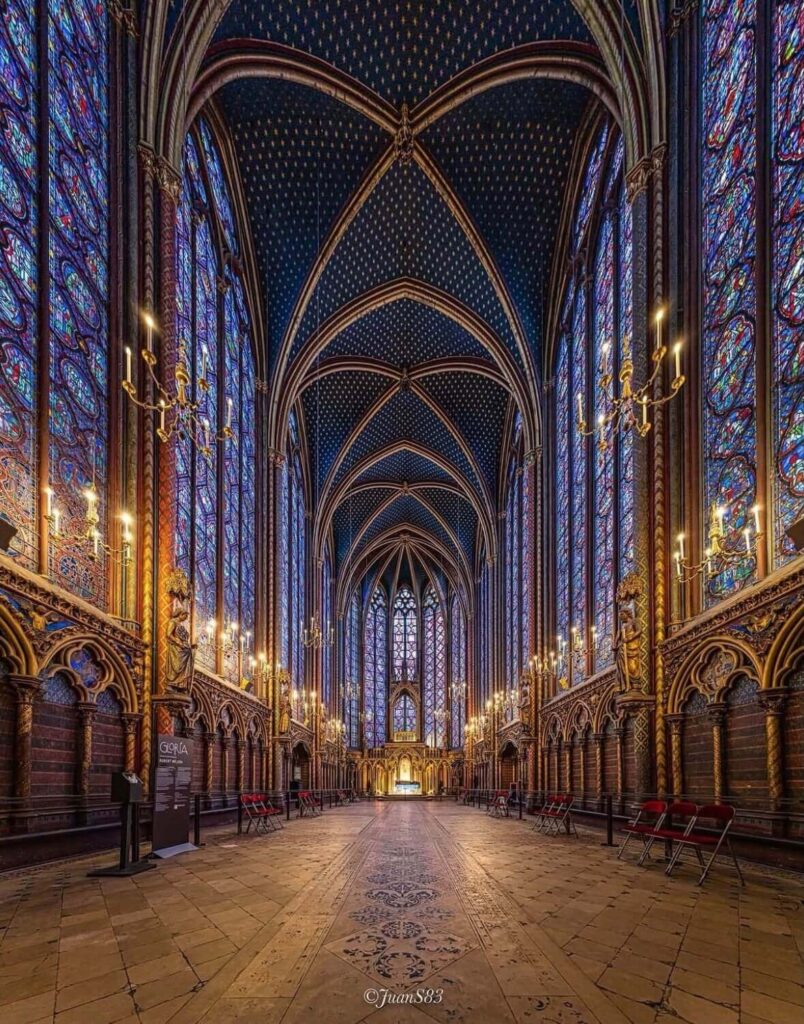 Interior of Sainte-Chapelle upper chapel filled with stained glass light