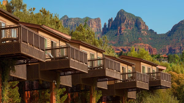 L'Auberge de Sedona luxury creekside cottages surrounded by lush trees and red rock scenery