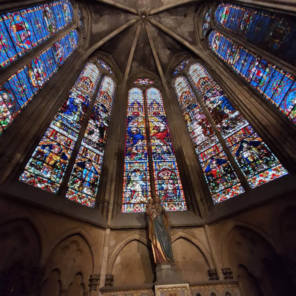 Interior of Metz Cathedral with colorful stained glass and vaulted Gothic ceilings