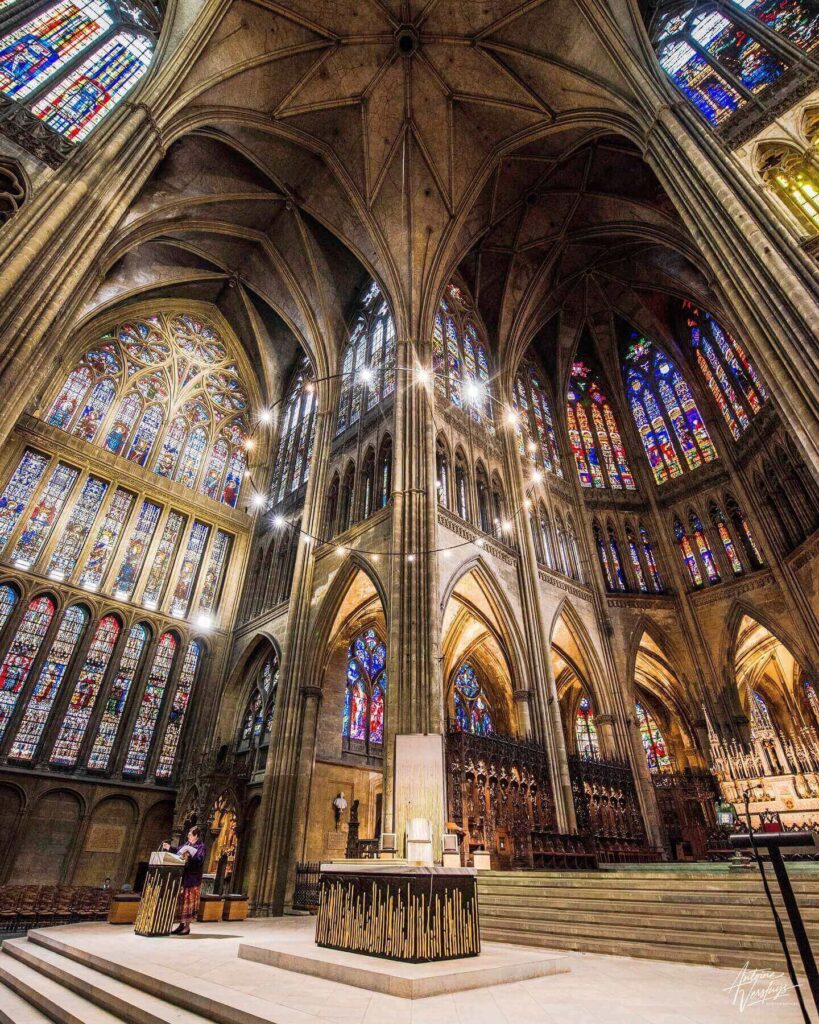 Midday sunlight illuminating stained glass inside Metz Cathedral