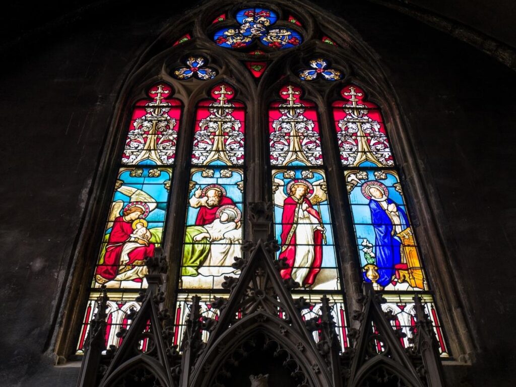 Bright midday light illuminating stained glass inside Metz Cathedral