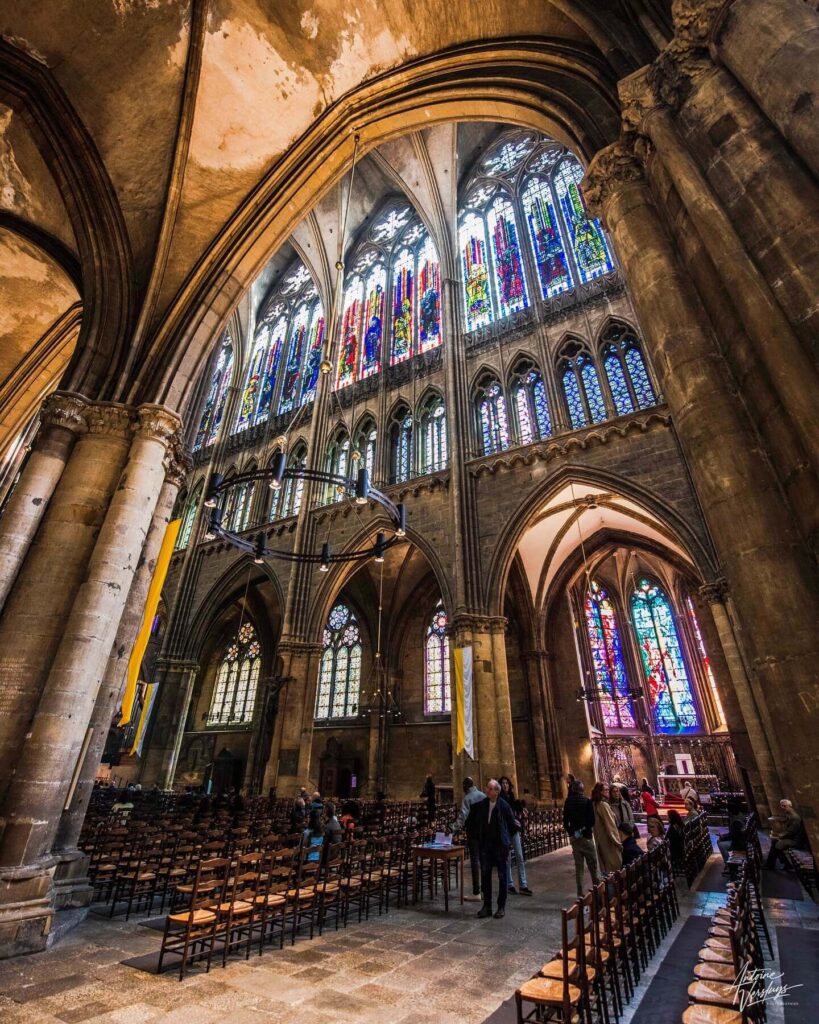 Visitor quietly exploring Metz Cathedral interior
