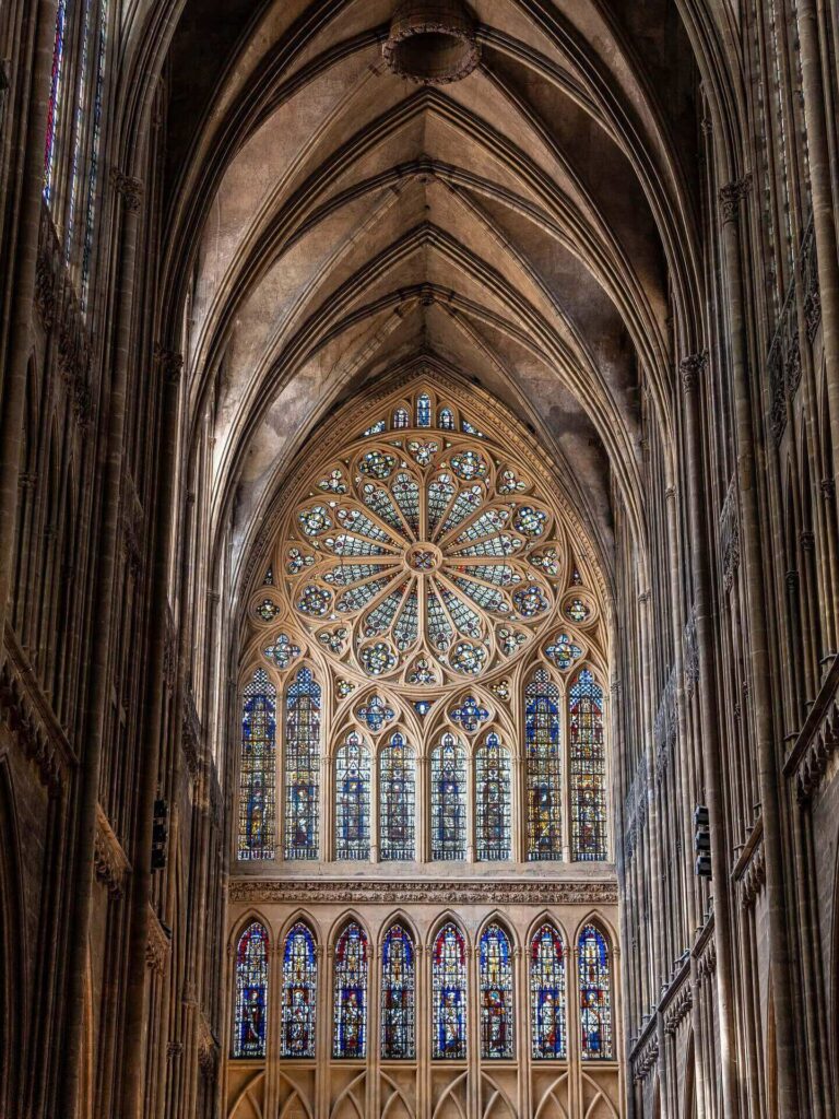 Sunlight illuminating stained glass windows inside Metz Cathedral