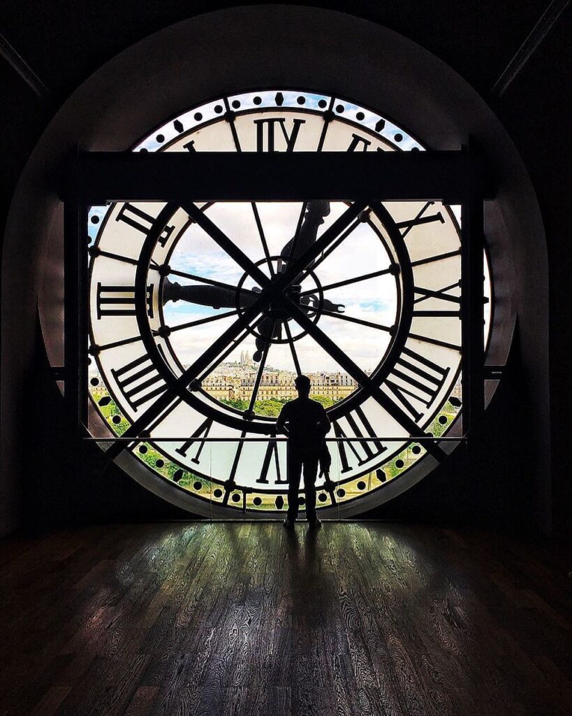 Visitors near the famous clock window inside Musée d'Orsay