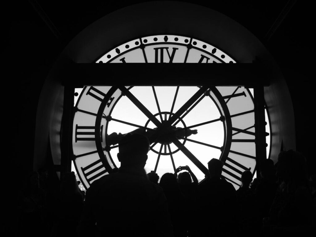 Visitors near the famous clock window inside Musée d'Orsay