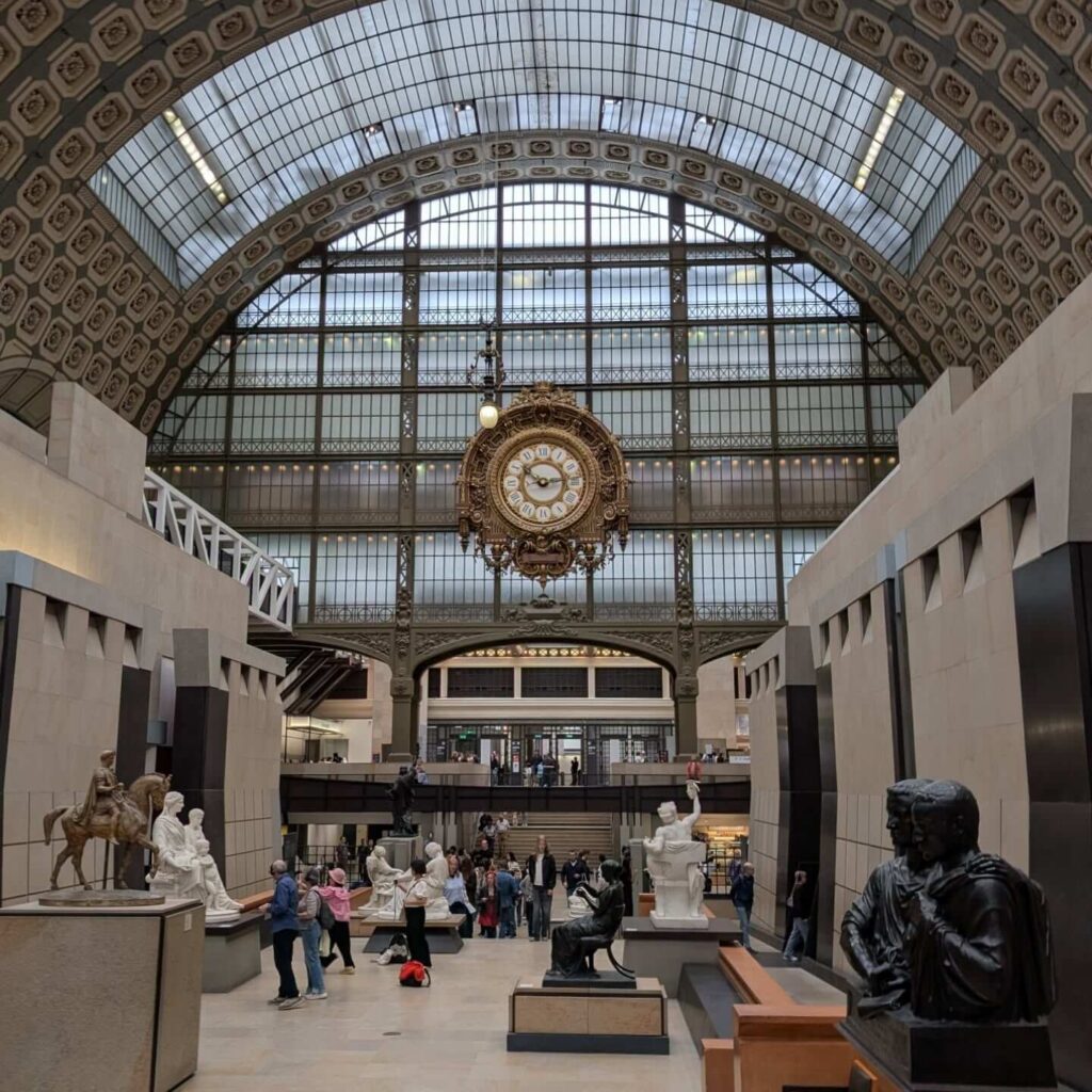 Grand central hall inside Musée d'Orsay with sculptures and historic architecture