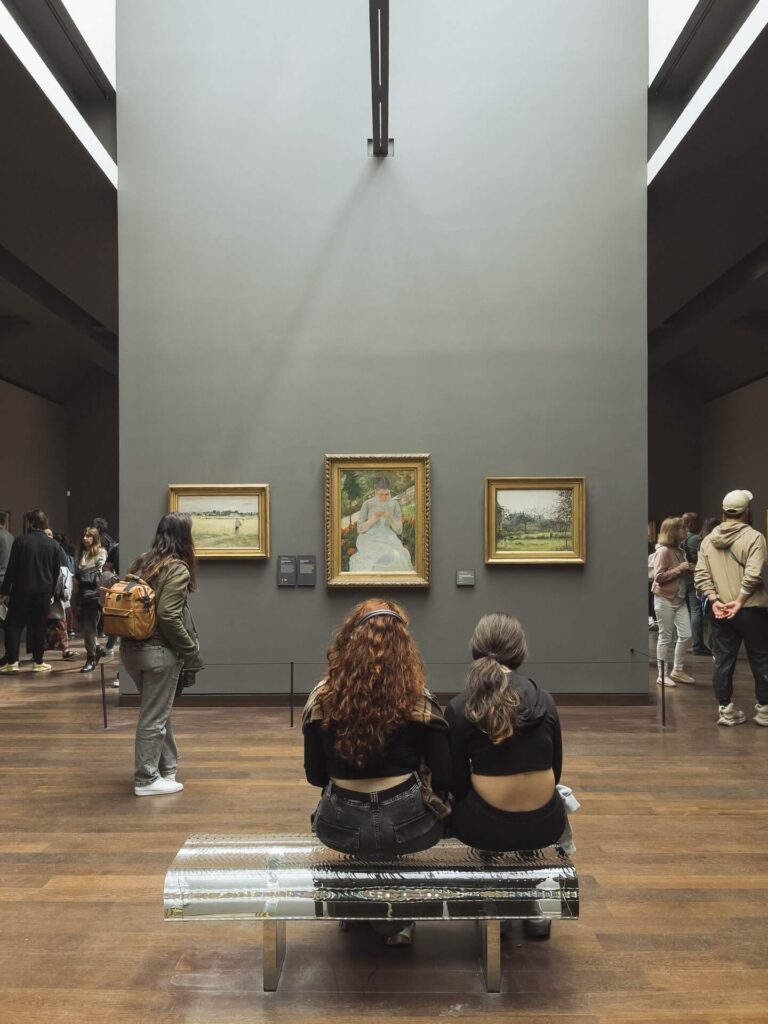 Visitors exploring the Impressionist galleries inside Musée d'Orsay