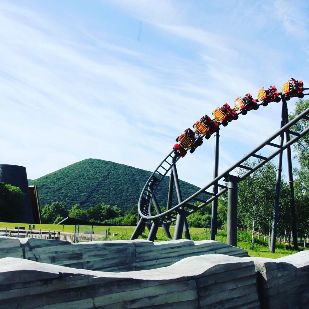 Visitors riding the Namazu attraction at Vulcania