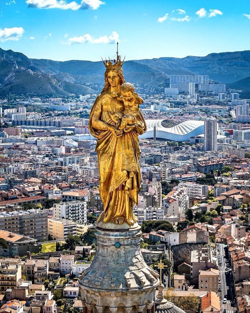 Exterior of Notre Dame de la Garde basilica with the golden Virgin Mary statue