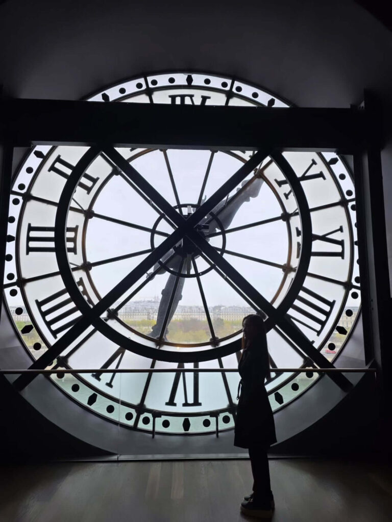View of Paris skyline through Musée d'Orsay clock window