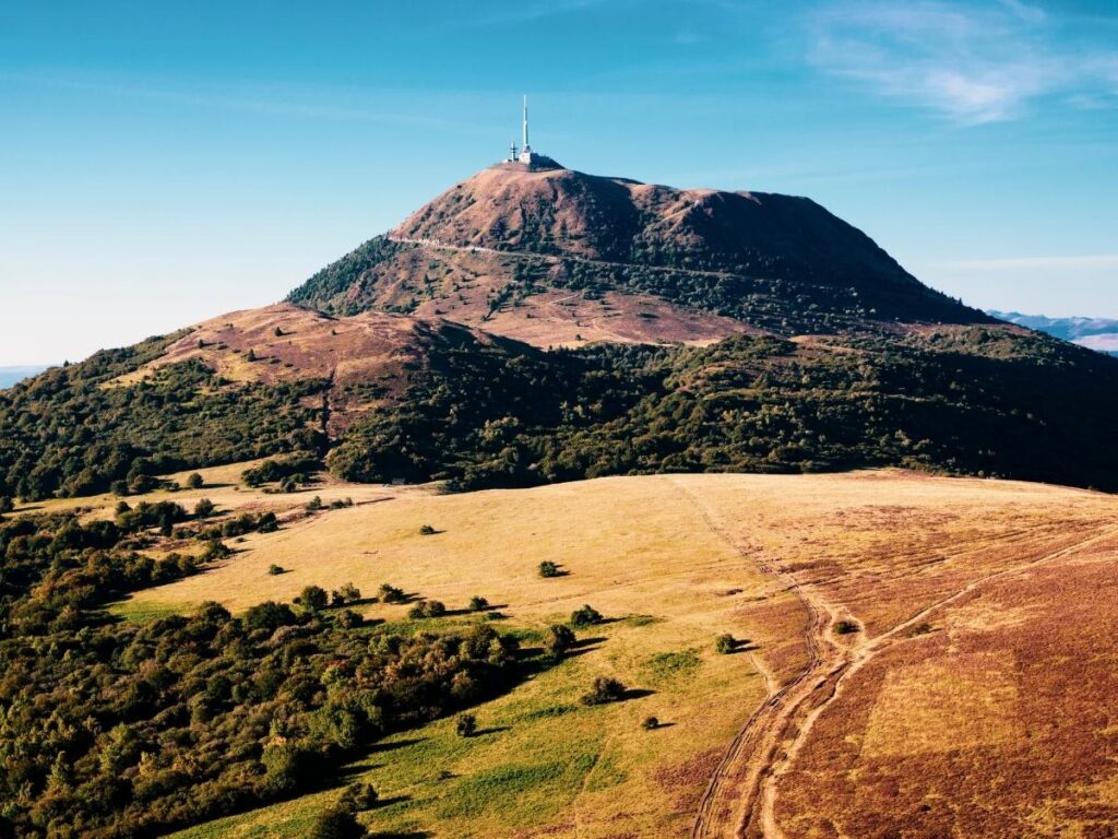 Puy de Dôme rising above the volcanic hills of the Chaîne des Puys in France