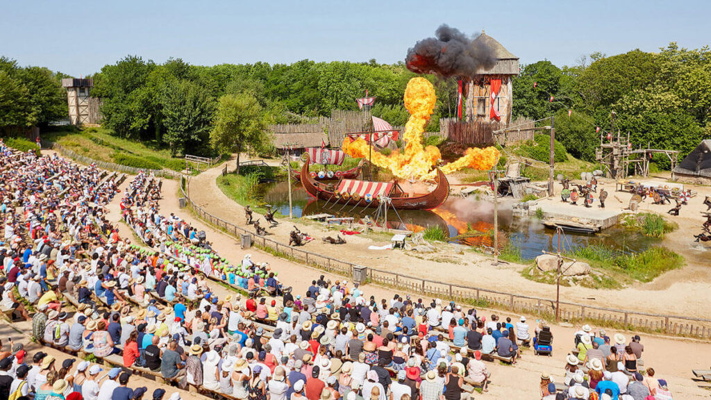 Visitors walking through Puy du Fou during warm weather