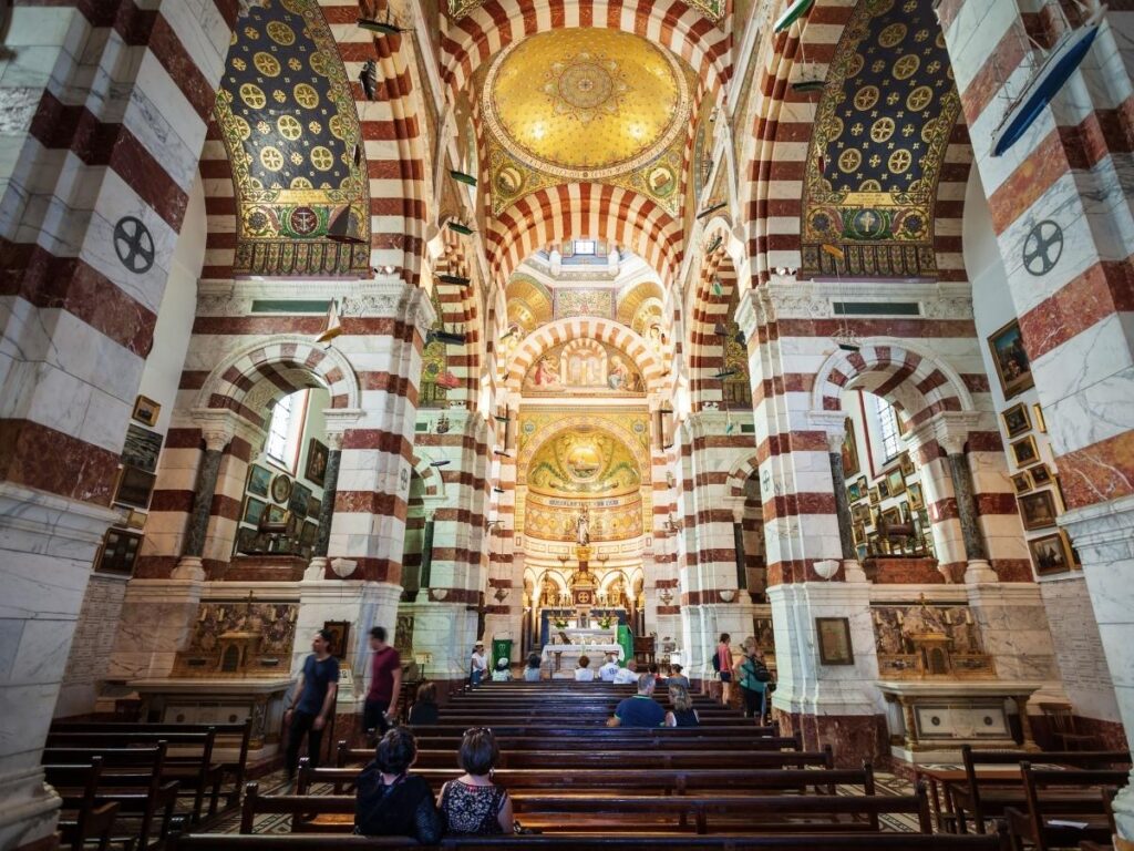 Visitors sitting quietly inside Notre Dame de la Garde