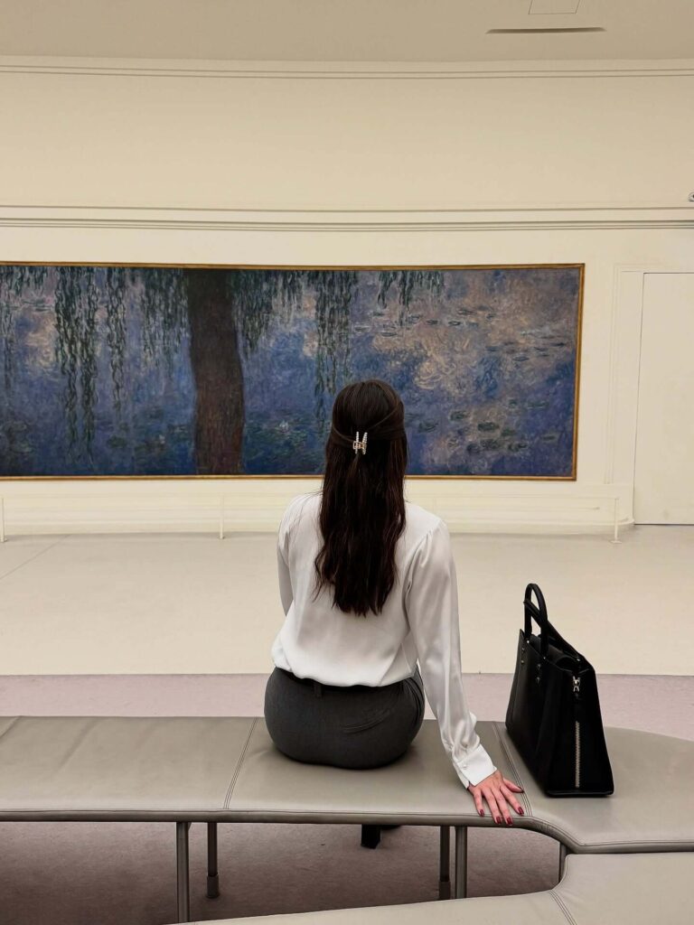 Visitors slowly admiring paintings inside Musée de l'Orangerie