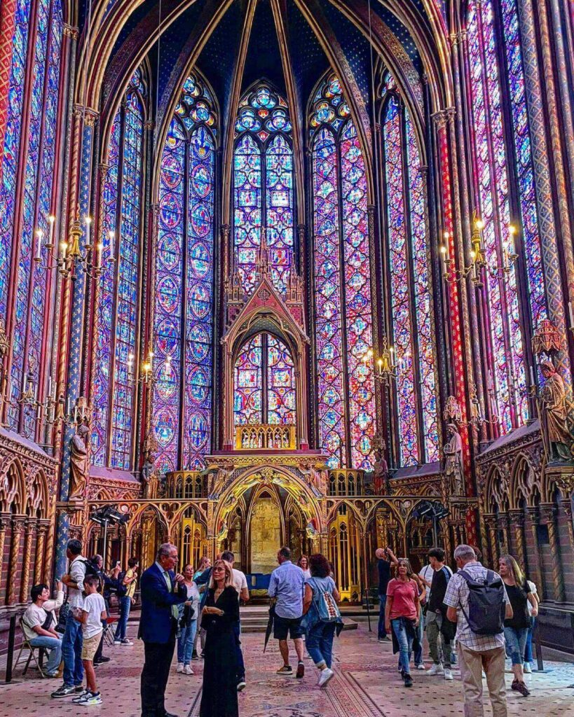 Visitor sitting quietly inside Sainte-Chapelle upper chapel