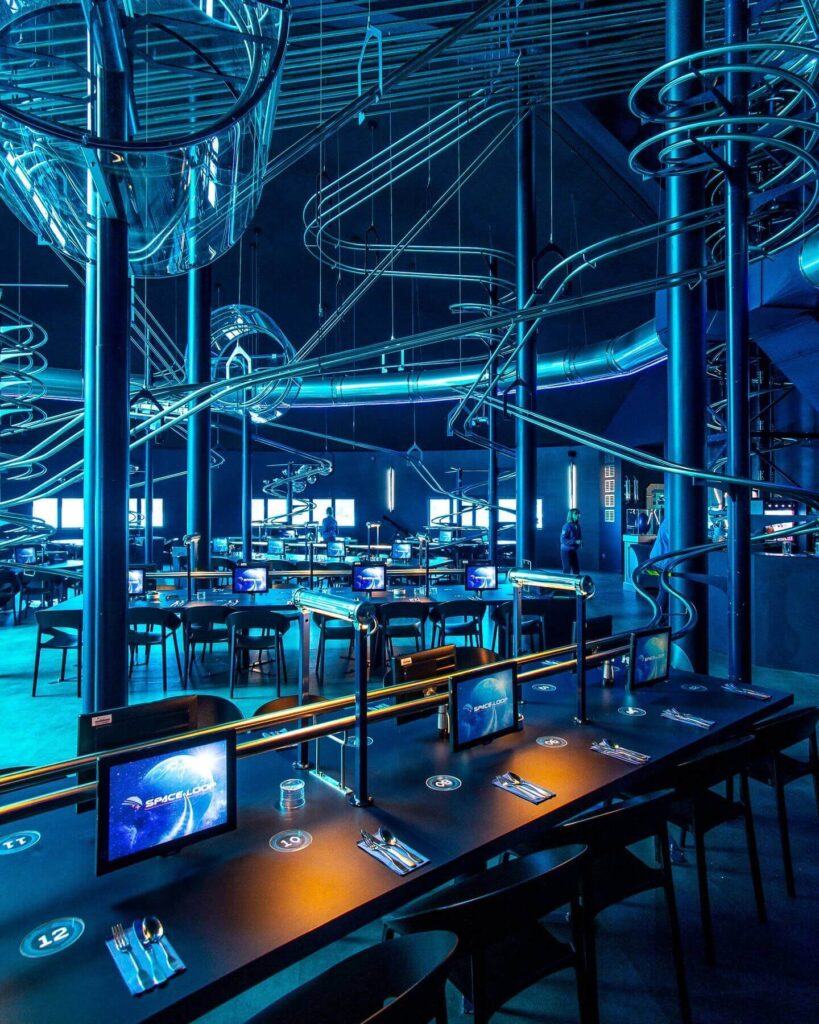 Space Loop restaurant with roller coaster food delivery tracks