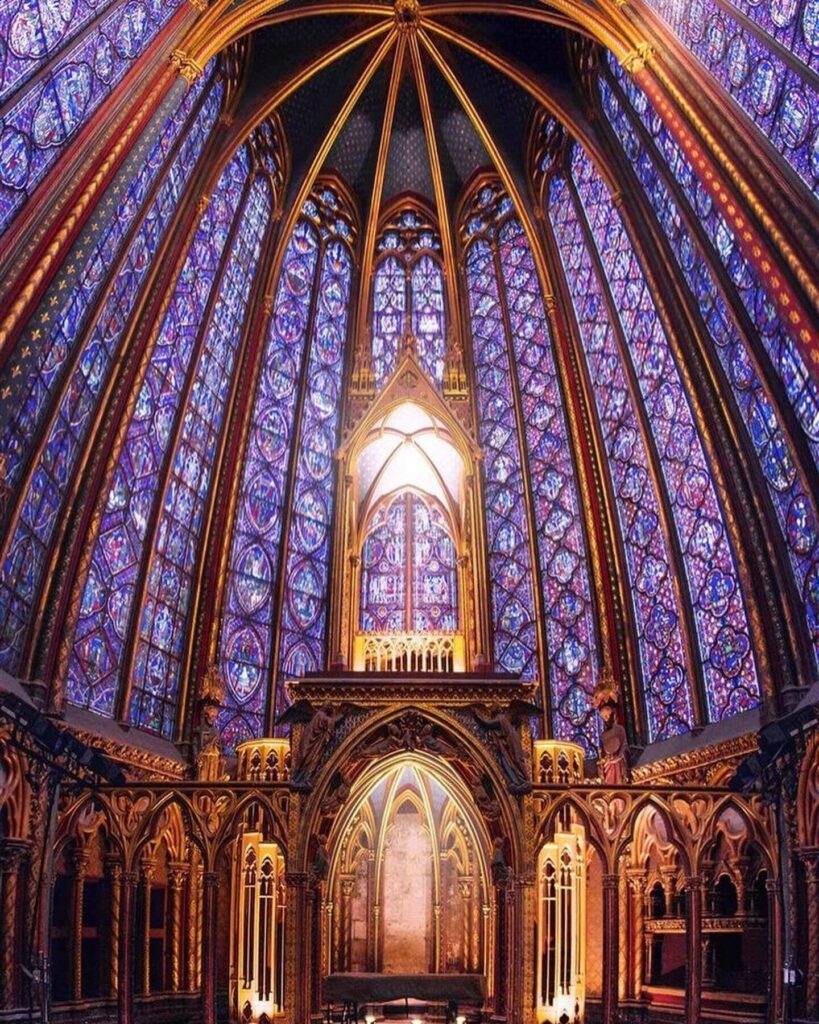 Sunlight illuminating stained glass windows inside Sainte-Chapelle