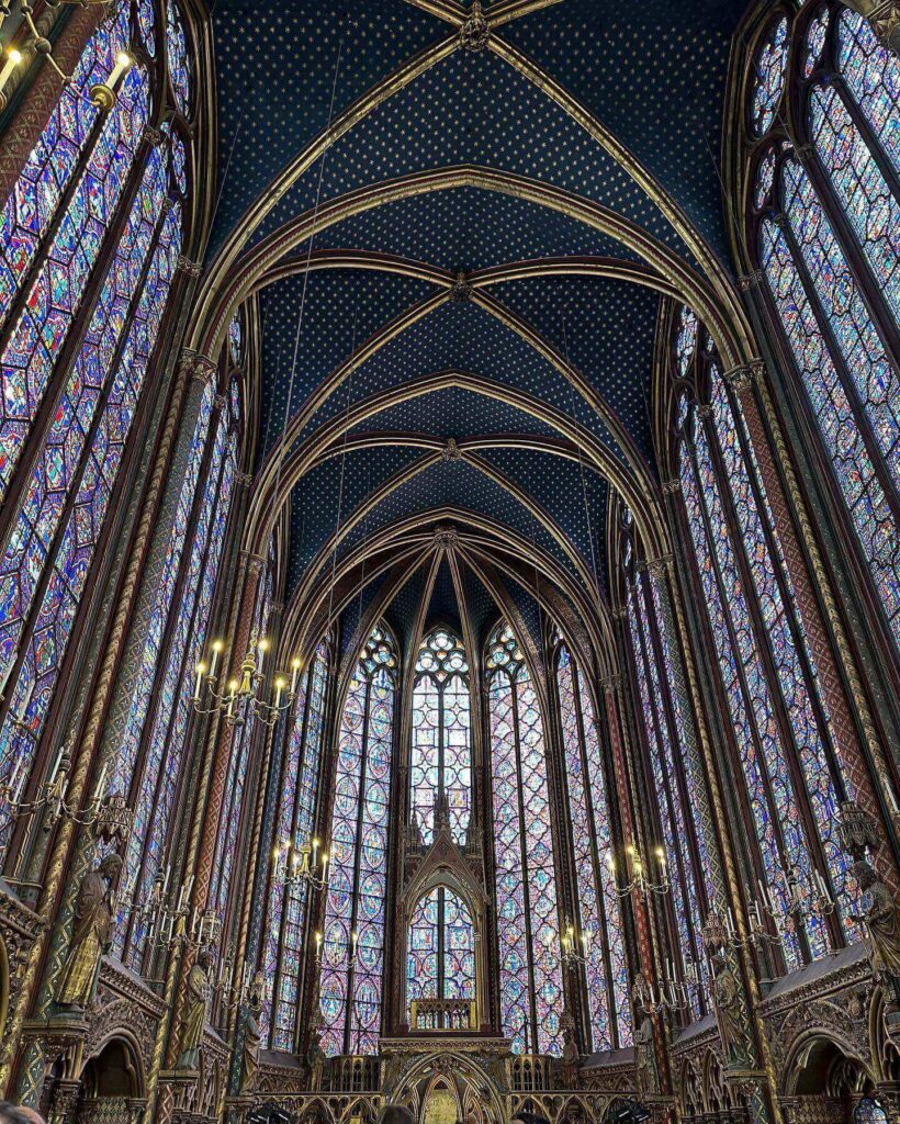 Sunlight glowing through stained glass windows inside Sainte-Chapelle