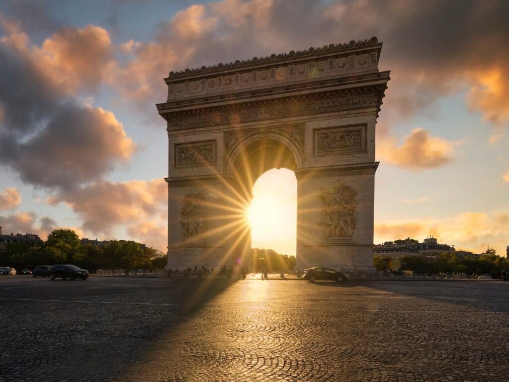 Visitors waiting outside the Arc de Triomphe near sunset