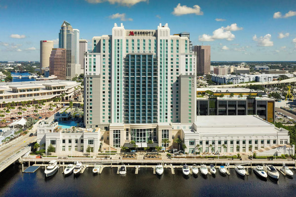 Exterior view of Tampa Marriott Water Street, a reliable crowd-pleasing waterfront hotel in downtown Tampa featuring modern architecture, marina views, palm trees, and vibrant city atmosphere.