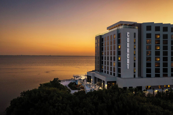 Waterfront view of The CURRENT Hotel, Autograph Collection featuring modern coastal design, stylish luxury accommodations, panoramic Tampa Bay views, and a relaxing contemporary atmosphere.
