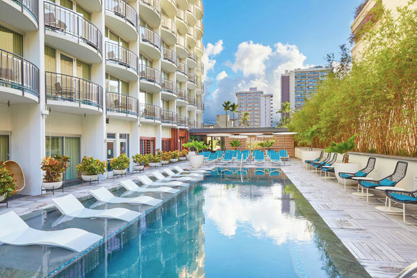Stylish tropical-inspired exterior of The Laylow, Autograph Collection showcasing modern boutique hotel design in Waikiki, Hawaii.