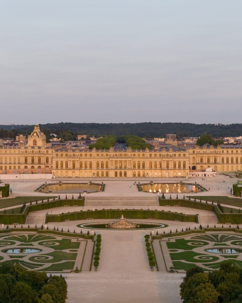 Visitors walking long distances across the large grounds of the Palace of Versailles