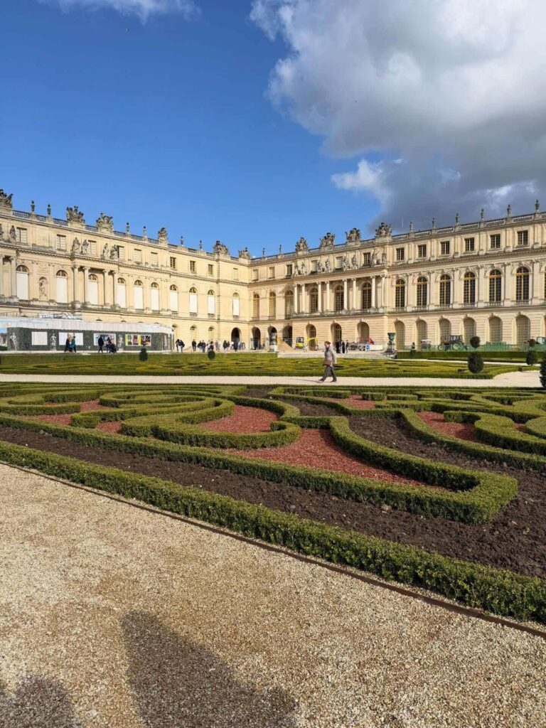 Wide view of the Palace of Versailles and gardens showing the full estate experience
