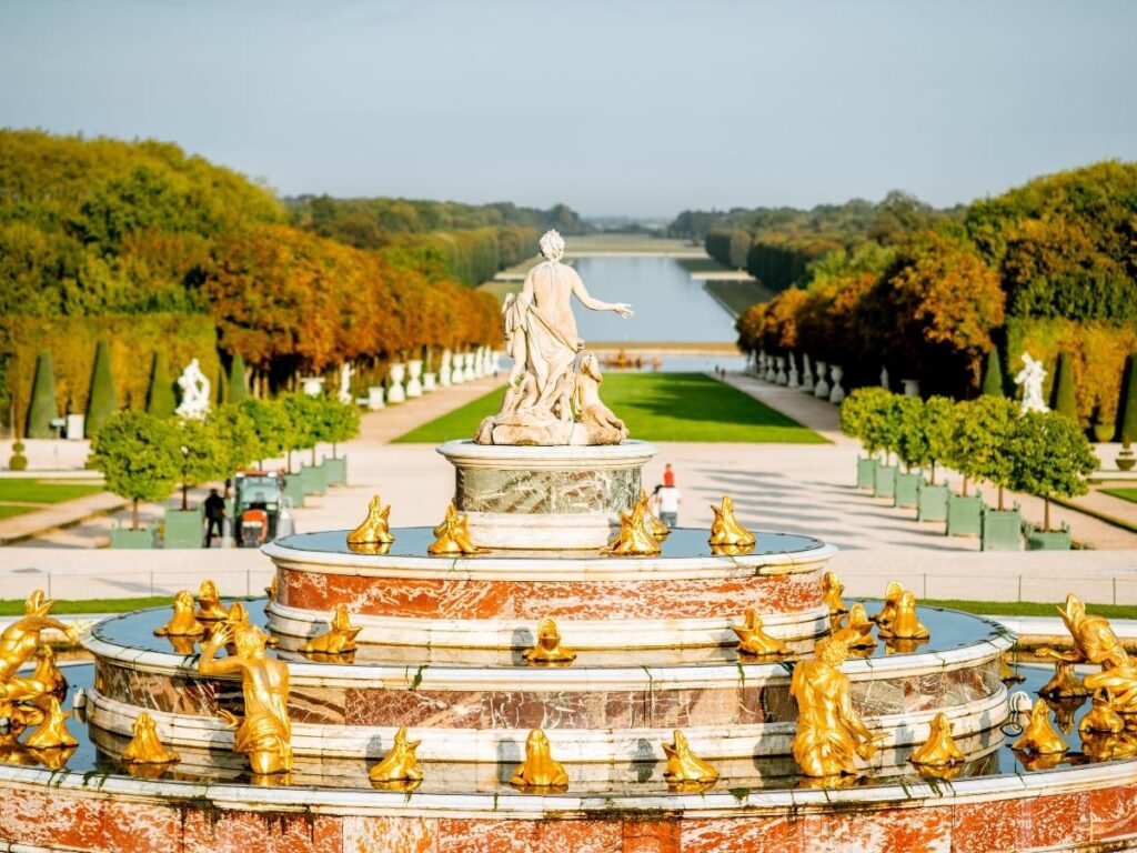 Versailles gardens in spring with green landscapes and active fountains