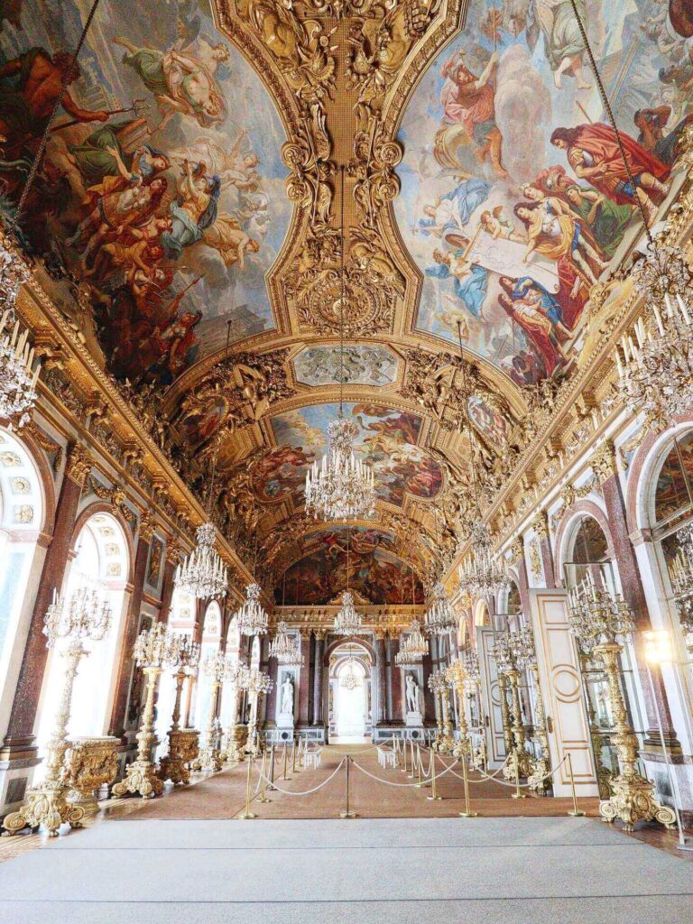 Contrast between busy palace interiors and open Versailles gardens