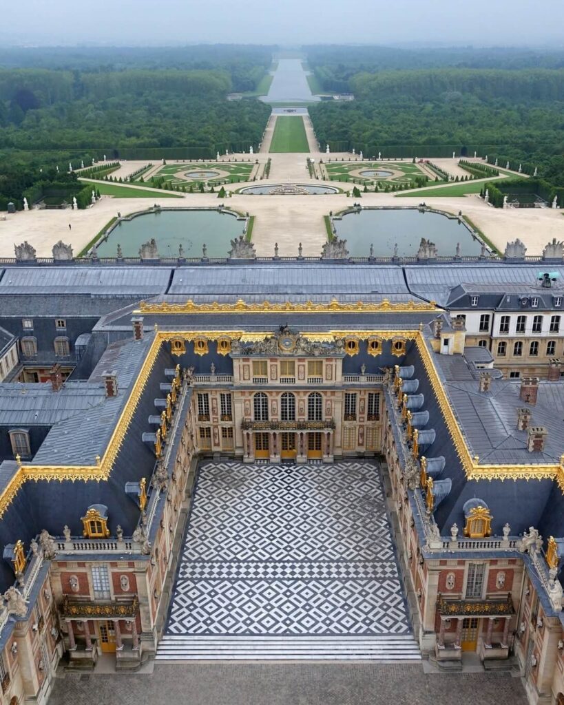 Symmetrical layout of the Palace of Versailles and its expansive gardens from above