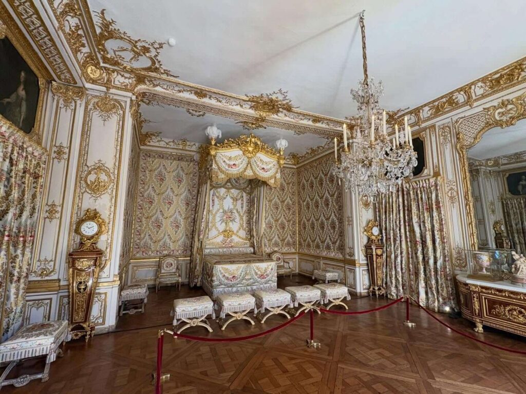 Decorated royal apartment room inside the Palace of Versailles with ornate furnishings