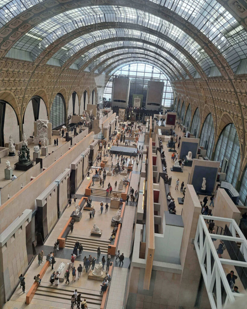 Visitor exploring the Impressionist galleries inside Musée d'Orsay Paris