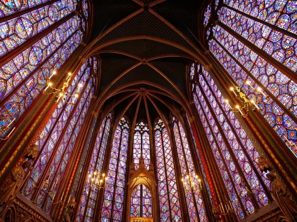 Visitor admiring the stained glass inside Sainte-Chapelle in Paris