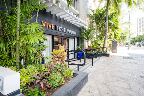 Contemporary boutique exterior of VIVE Hotel Waikiki featuring stylish modern accommodations near Waikiki Beach in Hawaii.