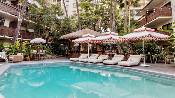 Tropical courtyard and pool area at White Sands Hotel showcasing retro boutique resort charm in Waikiki, Hawaii.